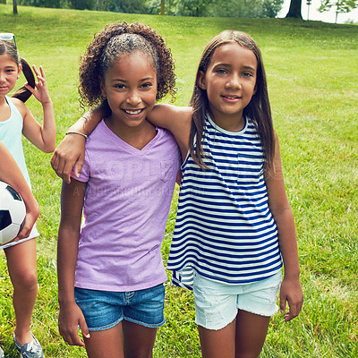 Buy stock photo Shot of two young girls hanging out with their friends in the park