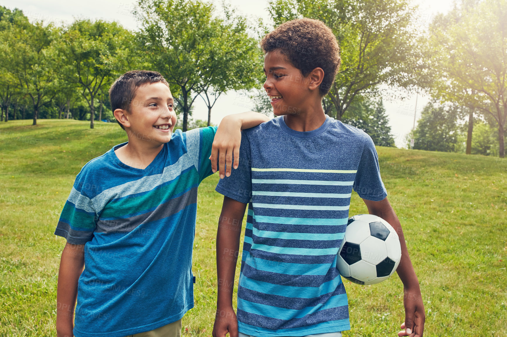 Buy stock photo Boys, children and walking in park with soccer ball for happiness, development or bonding together. Morning, friends and young kids with smile for fun, summer vacation or weekend adventure in nature