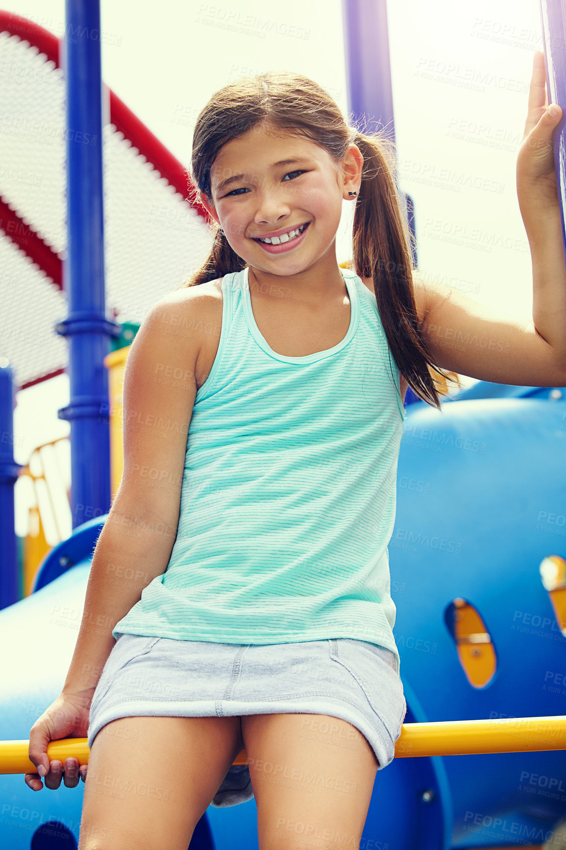 Buy stock photo Shot of a young girl playing on a jungle gym in the park