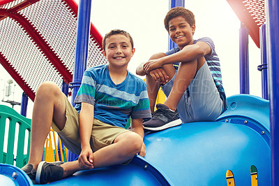 Buy stock photo Shot of two young boys playing on the jungle gym in the park