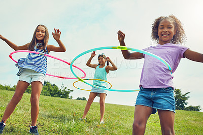 Buy stock photo Portrait, kids and girls with hula hoop, outdoor and happiness with fun, bonding together or leisure in park. Childhood, summer or friends with recreation, game or cheerful with weekend break or play