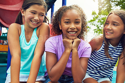 Buy stock photo Shot of a group of young friends hanging out together at a playground