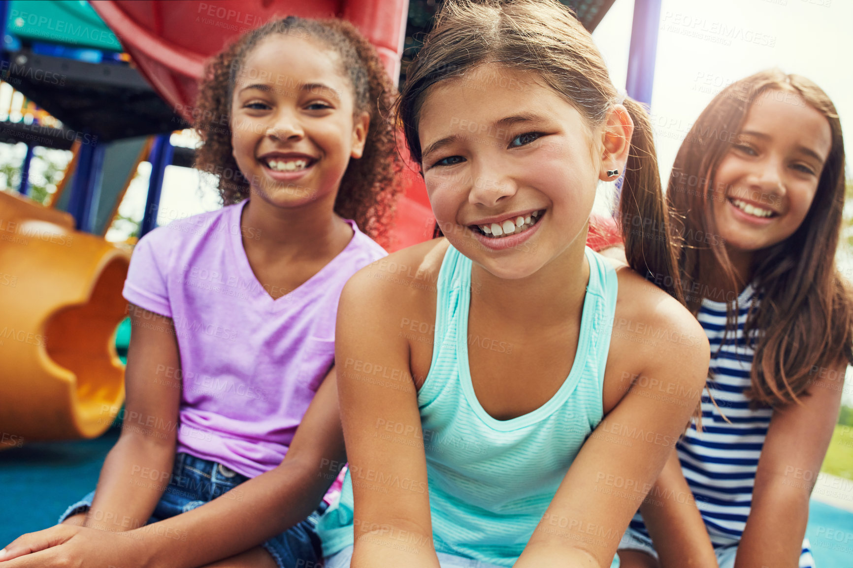 Buy stock photo Shot of a group of young friends hanging out together at a playground