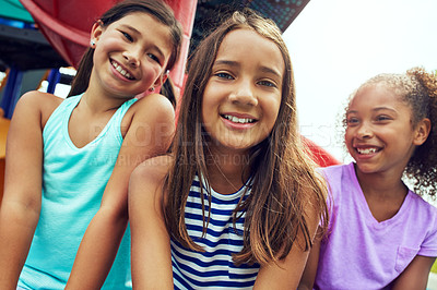 Buy stock photo Shot of a group of young friends hanging out together at a playground