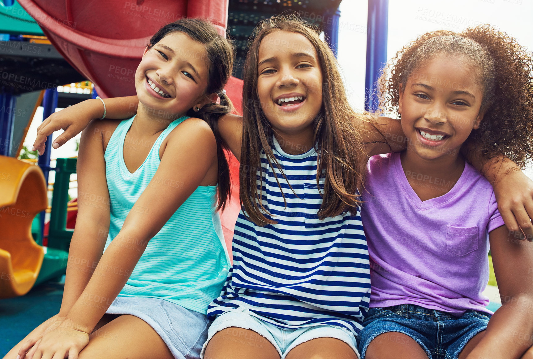 Buy stock photo Shot of a group of young friends hanging out together at a playground