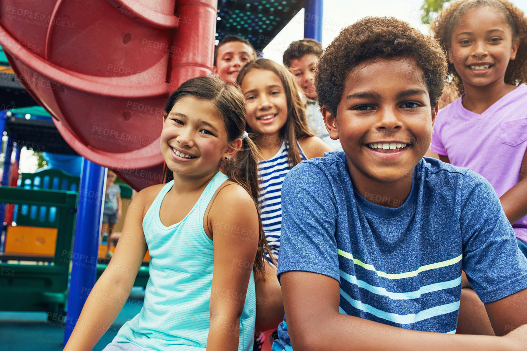 Buy stock photo Shot of a group of young friends hanging out together at a playground