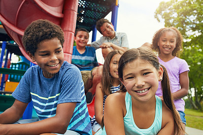 Buy stock photo Shot of a group of young friends hanging out together at a playground