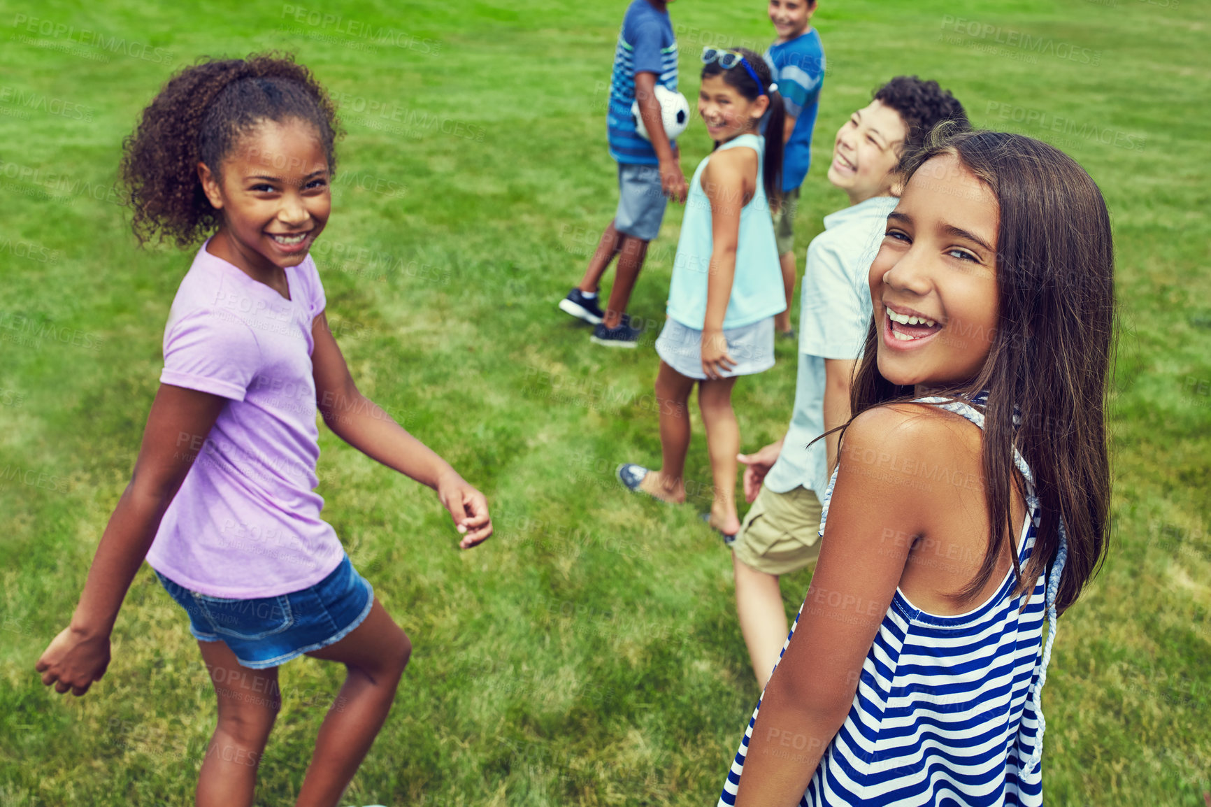 Buy stock photo Shot of a group of young friends hanging out together in the park