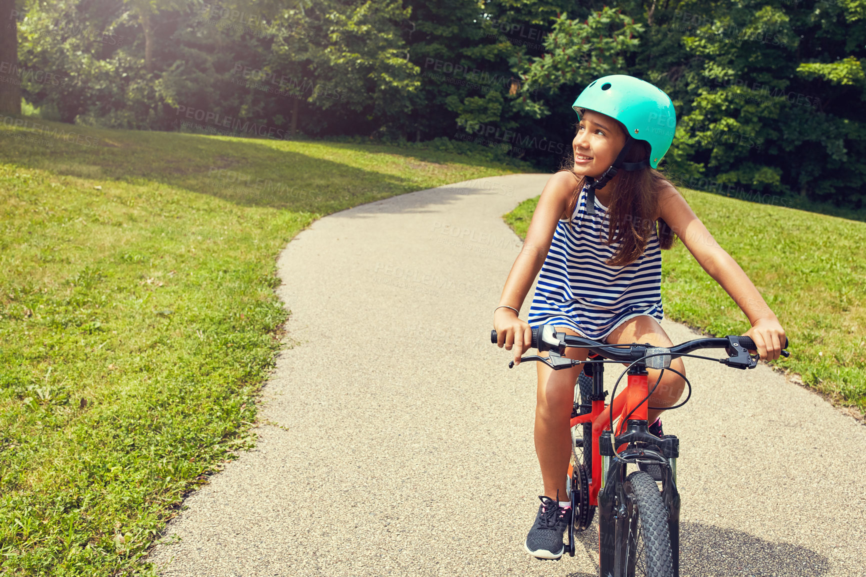 Buy stock photo Shot of a young girl out for a bicycle ride in the park