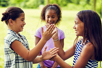 Buy stock photo Shot of adorable little girls playing hand games outdoors