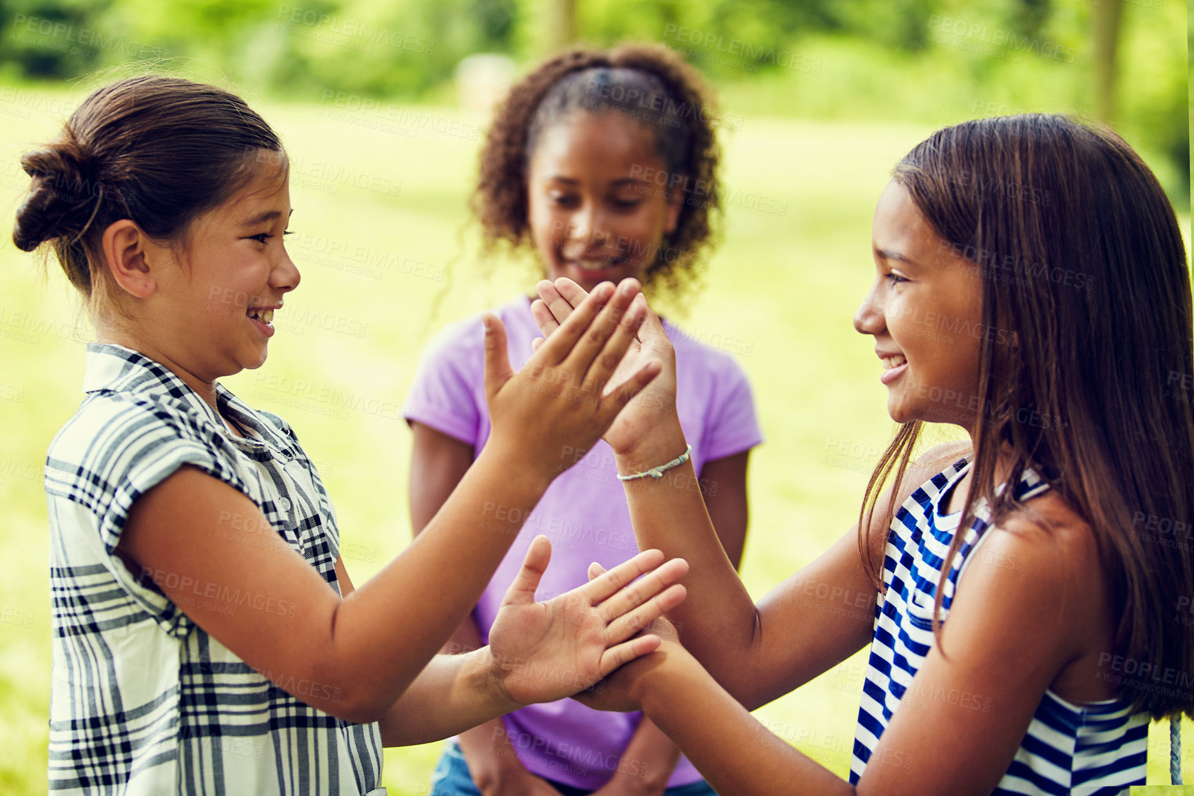 Buy stock photo Shot of adorable little girls playing hand games outdoors