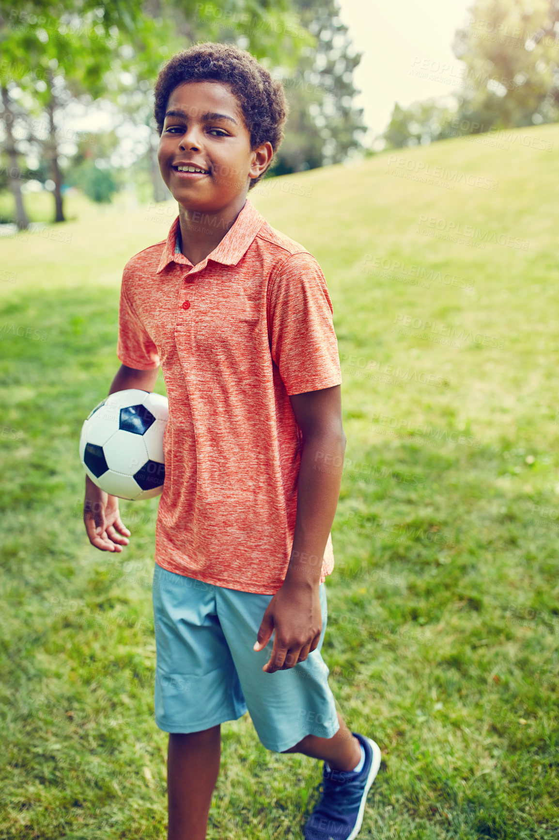 Buy stock photo Soccer, ball and portrait of child in park with smile, games and fun on outdoor holiday with confidence. Sports, kids and happy boy on grass with growth, development and summer camp for football.