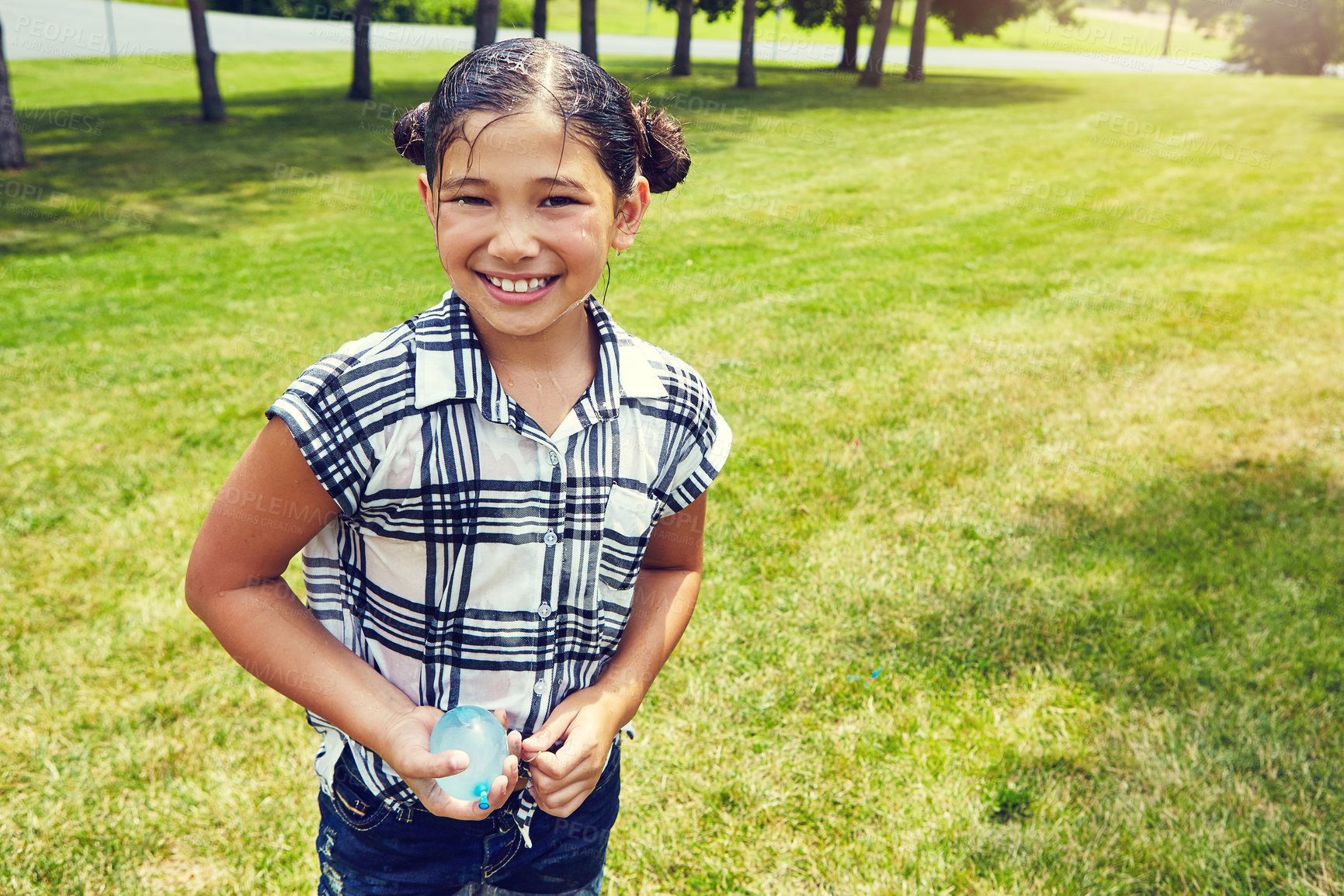 Buy stock photo Shot of an adorable little girl ready to throw balloons outdoors