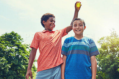 Buy stock photo Shot of adorable boys playing with water balloons outdoors