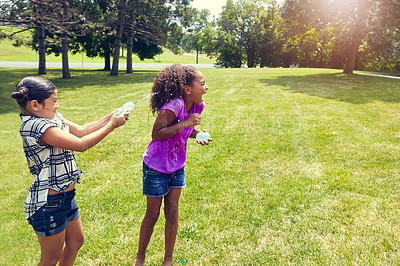 Buy stock photo Water, balloon and girl children in park with game, bonding and outdoor holiday together in garden. Playing, kids and happy friends on grass with fun, energy and splash on summer vacation in backyard