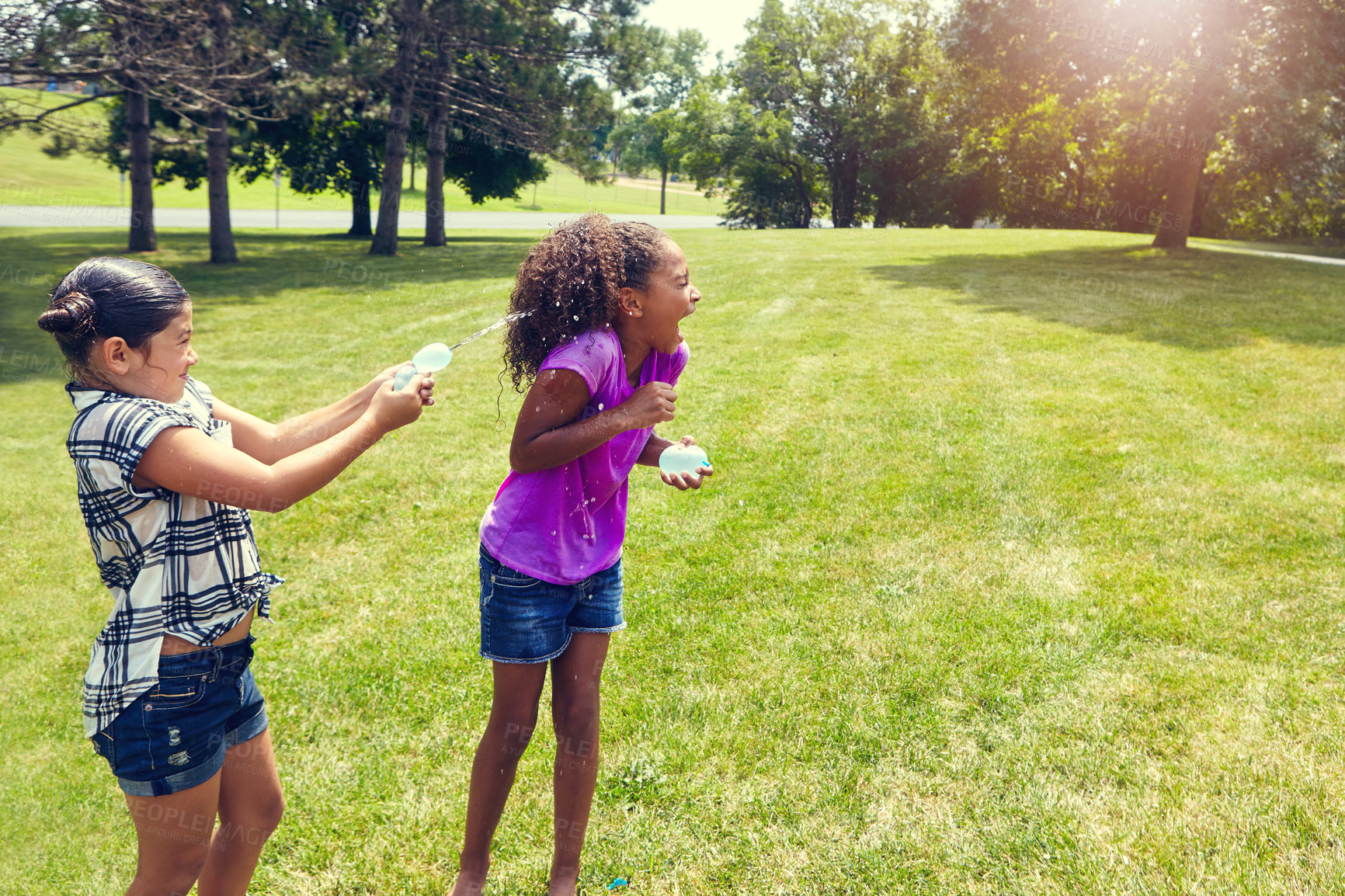 Buy stock photo Water, balloon and girl children in park with game, bonding and outdoor holiday together in garden. Playing, kids and happy friends on grass with fun, energy and splash on summer vacation in backyard