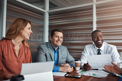 Buy stock photo Portrait of a businessman sitting alongside his colleagues during a meeting in an office