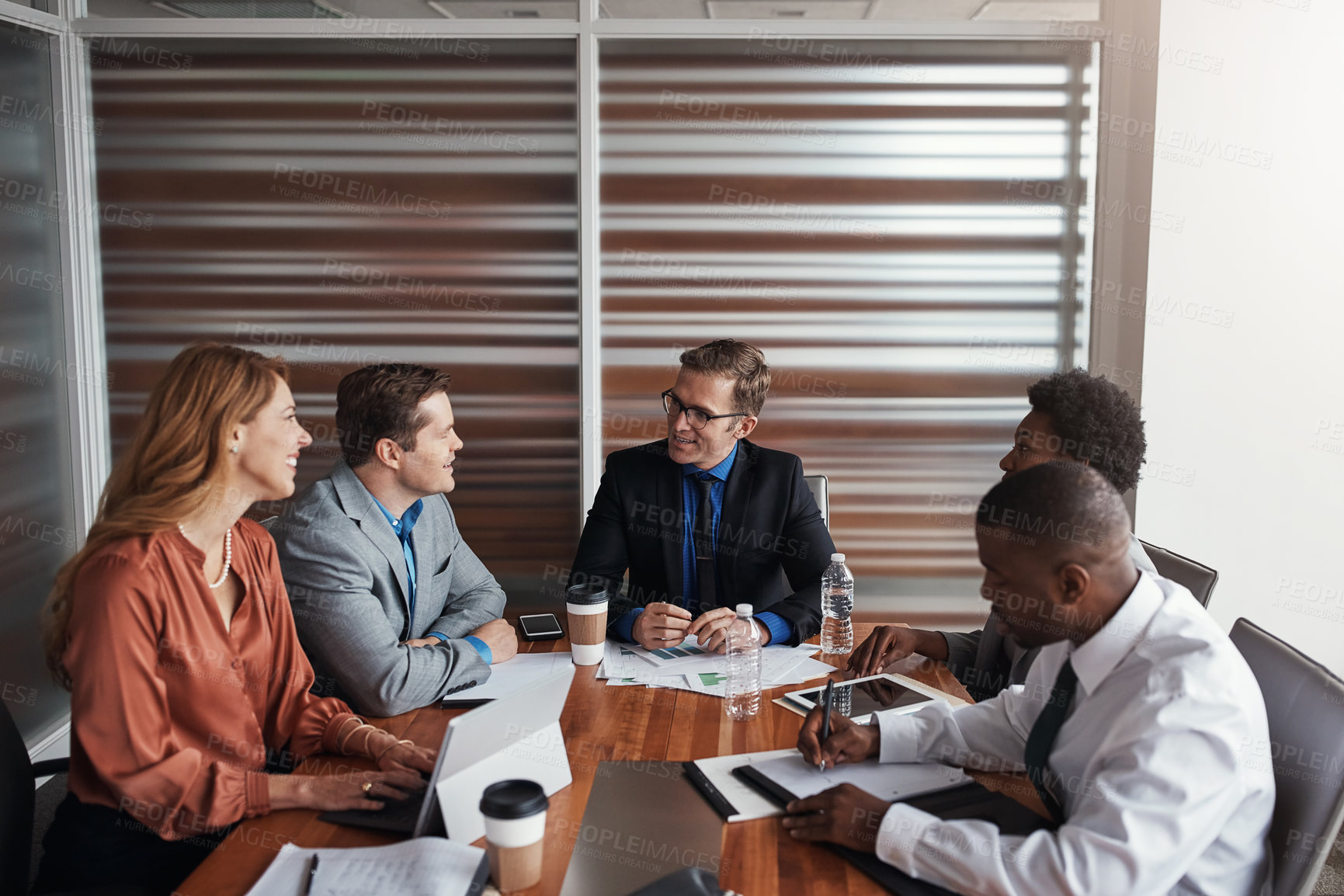 Buy stock photo Shot of a group of businesspeople having a meeting in an office