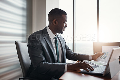 Buy stock photo Cropped shot of a handsome businessman working in his corporate office