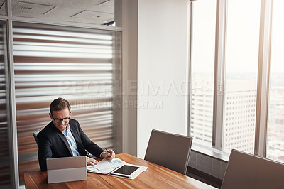 Buy stock photo High angle shot of a handsome businessman working in his corporate office