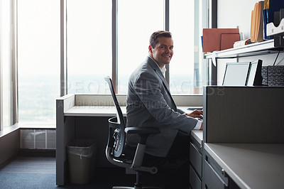 Buy stock photo Shot of a businessman working on his computer at his desk