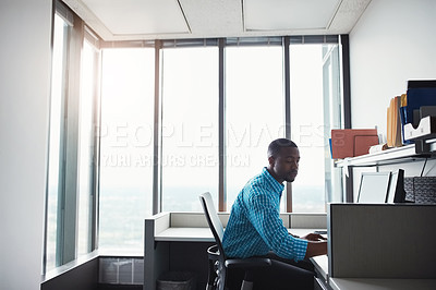 Buy stock photo Shot of a businessman working on his computer at his desk