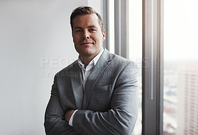 Buy stock photo Shot of a professional businessman standing in an office