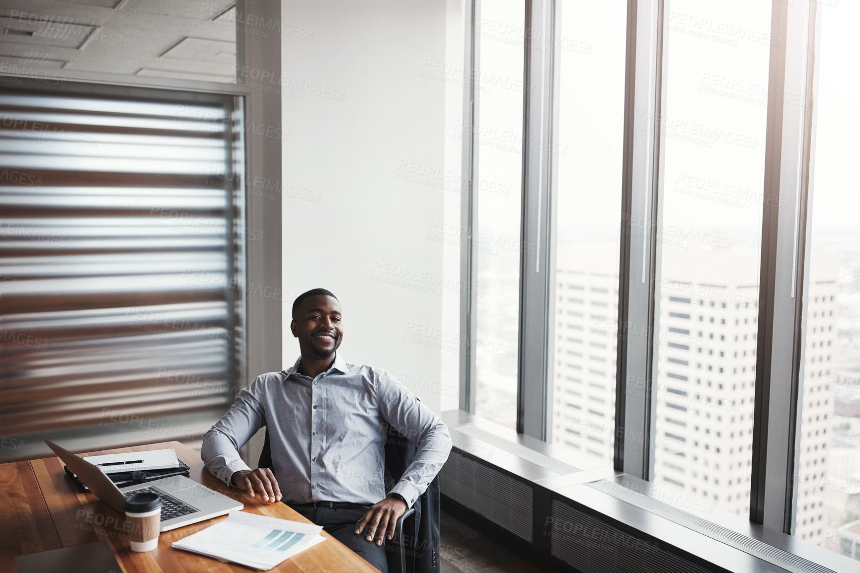 Buy stock photo High angle portrait of a handsome businessman working in his corporate office