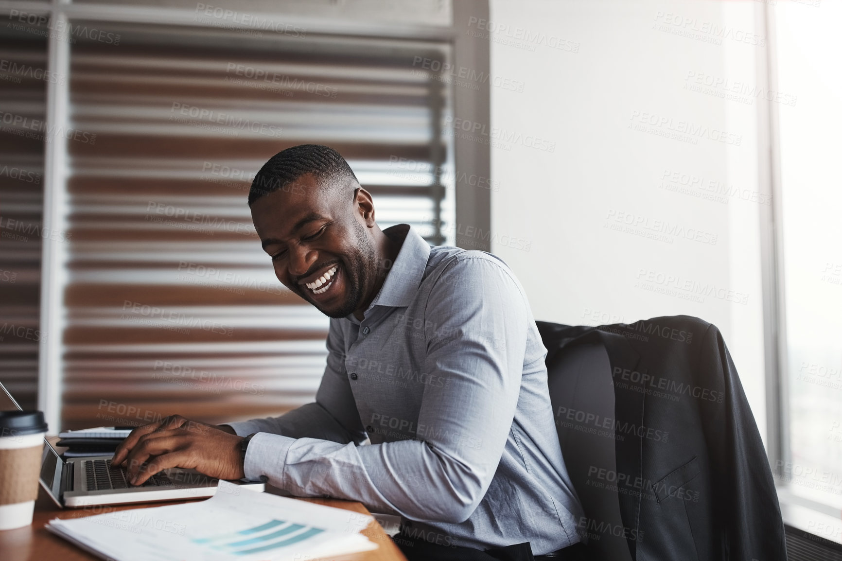 Buy stock photo Cropped shot of a handsome businessman laughing while working in his corporate office
