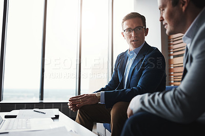 Buy stock photo Shot of two businessmen having a discussion in an office