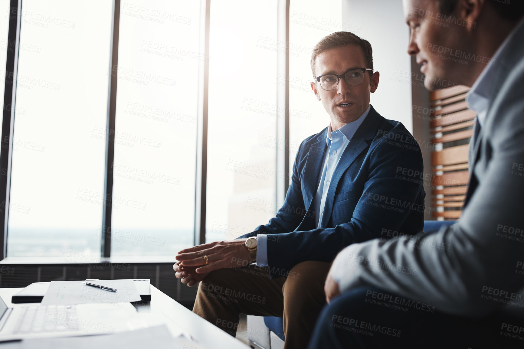 Buy stock photo Shot of two businessmen having a discussion in an office