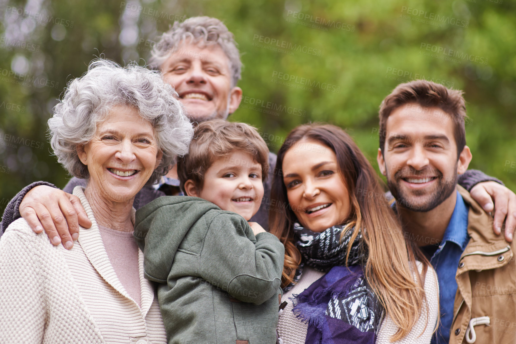 Buy stock photo Big family, happy and grandparents or parents with kid in a park on outdoor vacation, holiday with faces together. Mother, happiness and father smile with child for love, care and bonding in nature