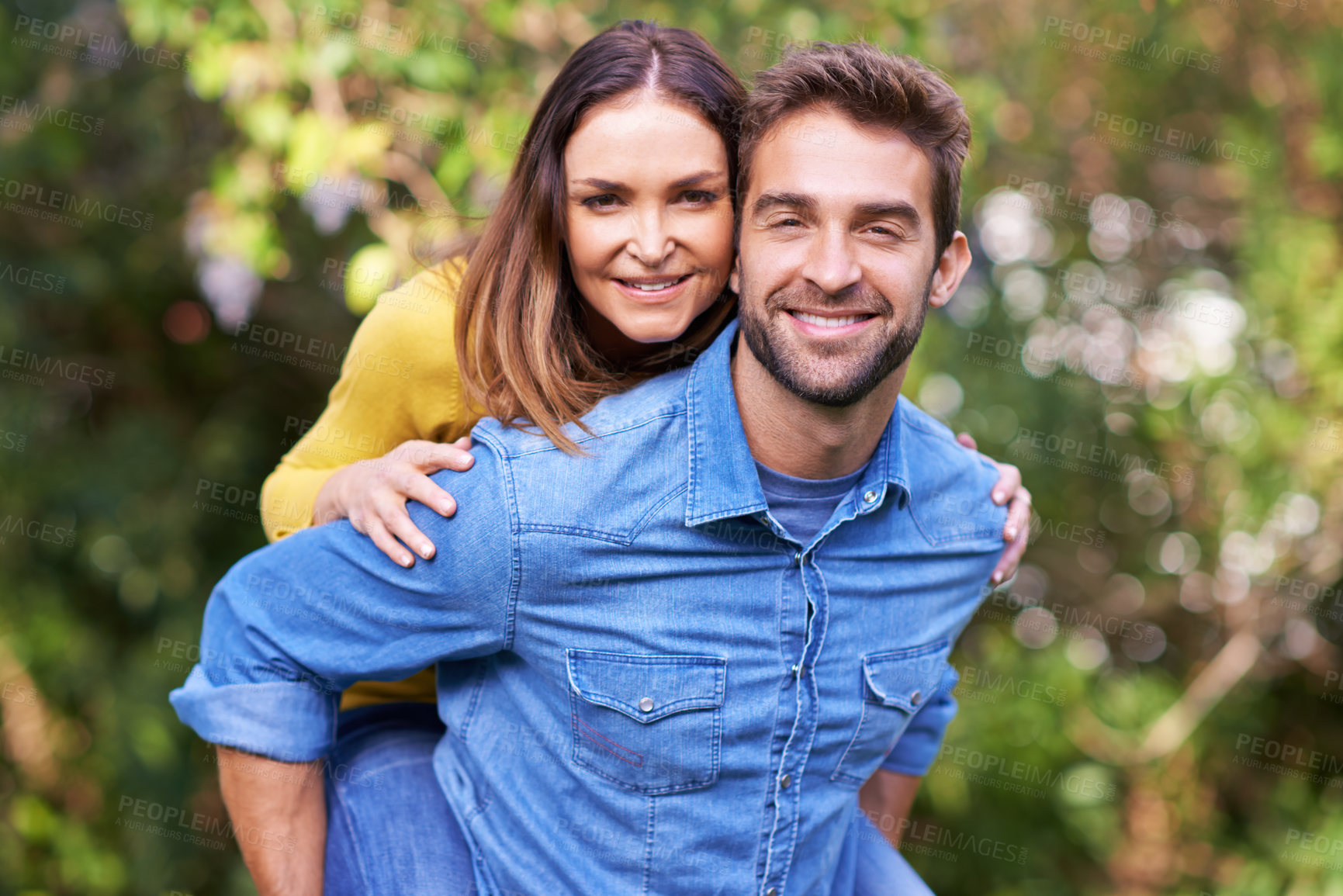 Buy stock photo Portrait, smile and happy couple with piggyback in nature or park for bonding, dating and relationship outdoor. People, love and romantic in backyard with joy, excited and playing in marriage