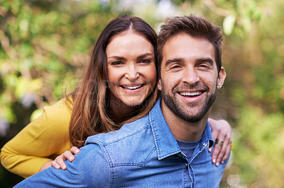 Buy stock photo Portrait, nature and happy couple with piggyback in park for bonding, dating and relationship outdoor. People, love and romantic in backyard with smile or joy, excited and commitment in marriage