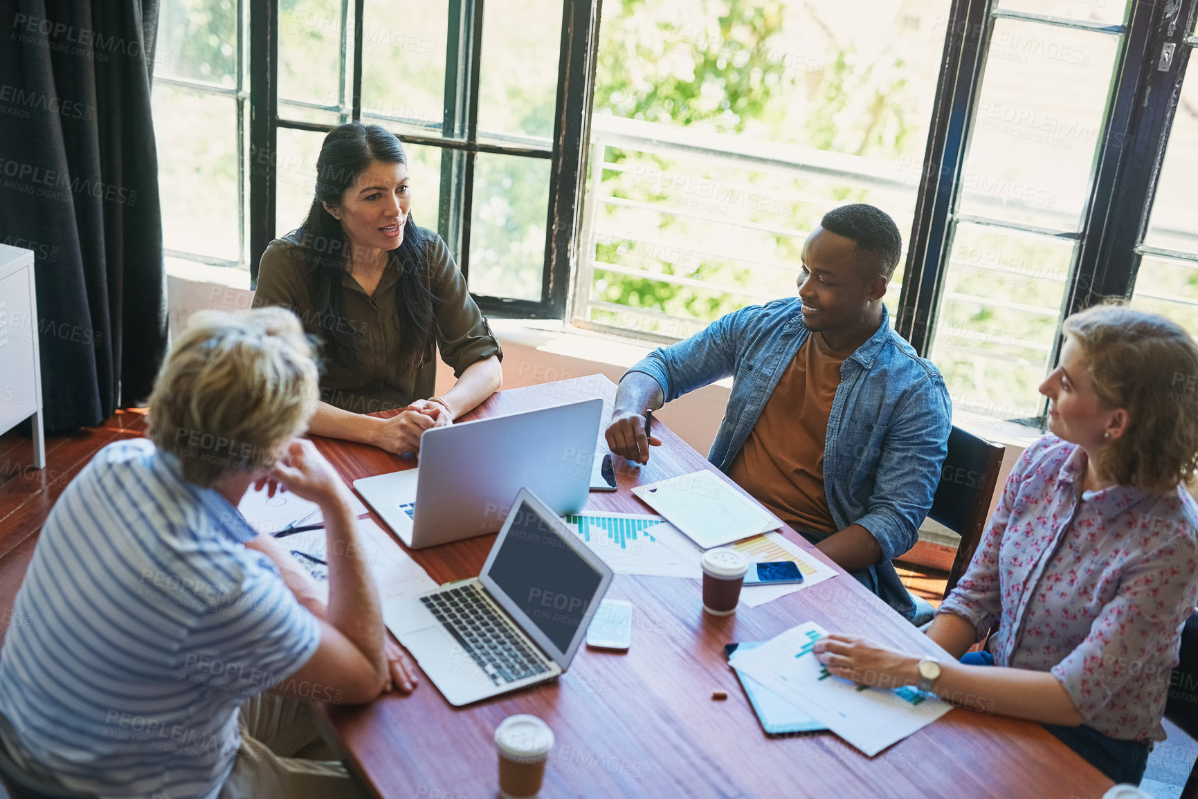 Buy stock photo Shot of a diverse group of businesspeople having a meeting in a modern office