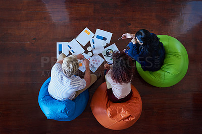 Buy stock photo Shot of a group of creative workers having a brainstorming session in an office