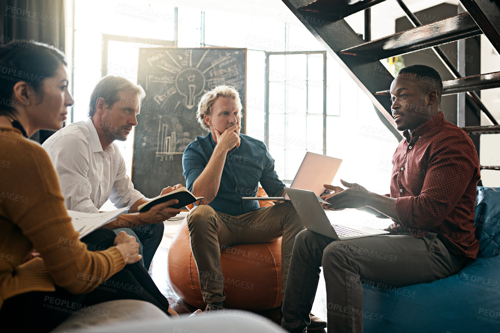 Buy stock photo Shot of a diverse group of designers brainstorming together in an office