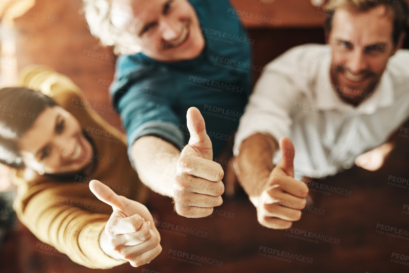 Buy stock photo High angle shot of a group of businesspeople showing thumbs up in an office