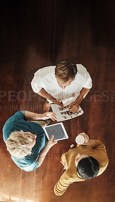 Buy stock photo High angle shot of a group of businesspeople brainstorming together in an office