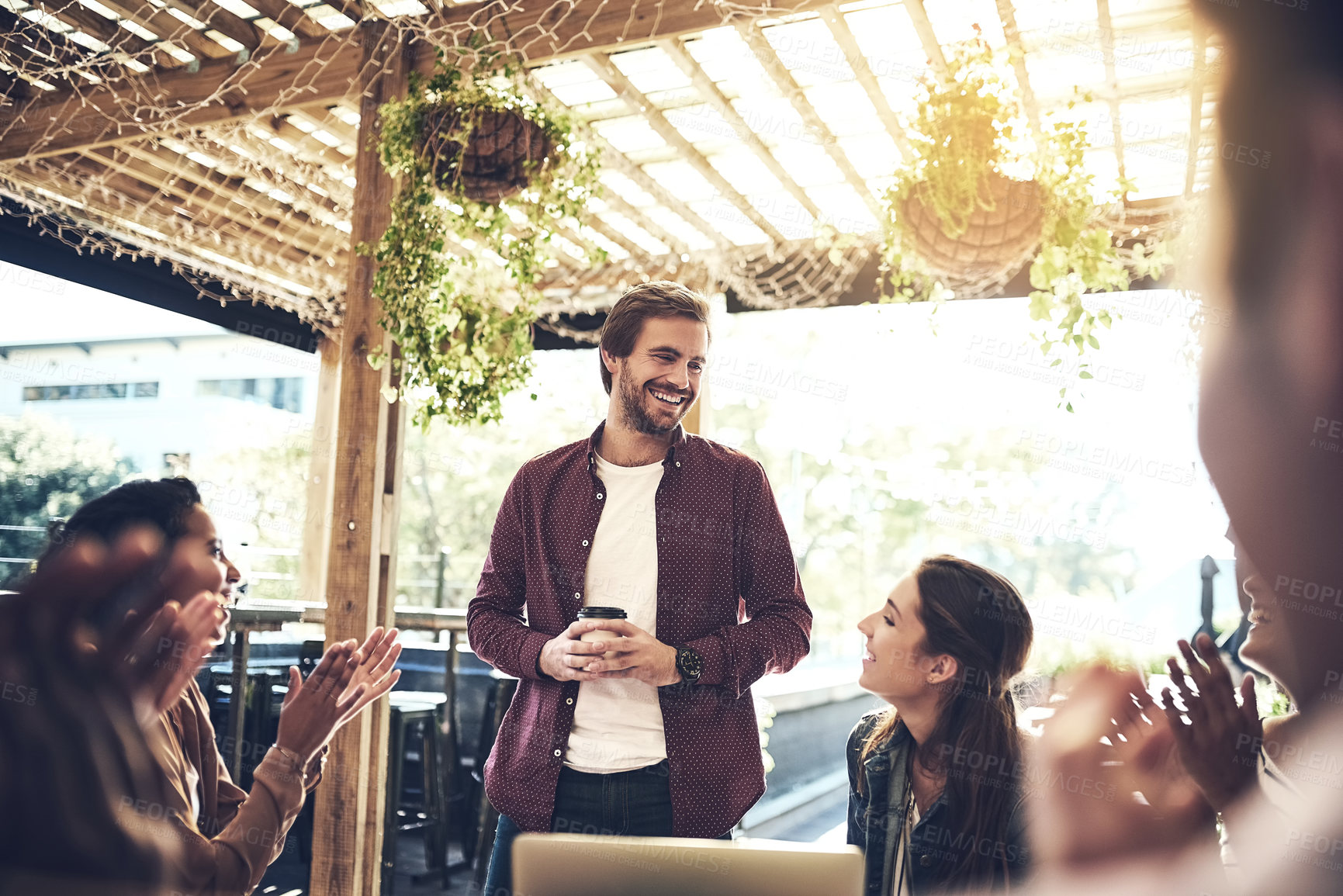 Buy stock photo Happy man, coffee and presentation with colleagues at cafe for meeting, discussion or introduction. Male person talking with smile to group of employees at coffee shop or restaurant for team building