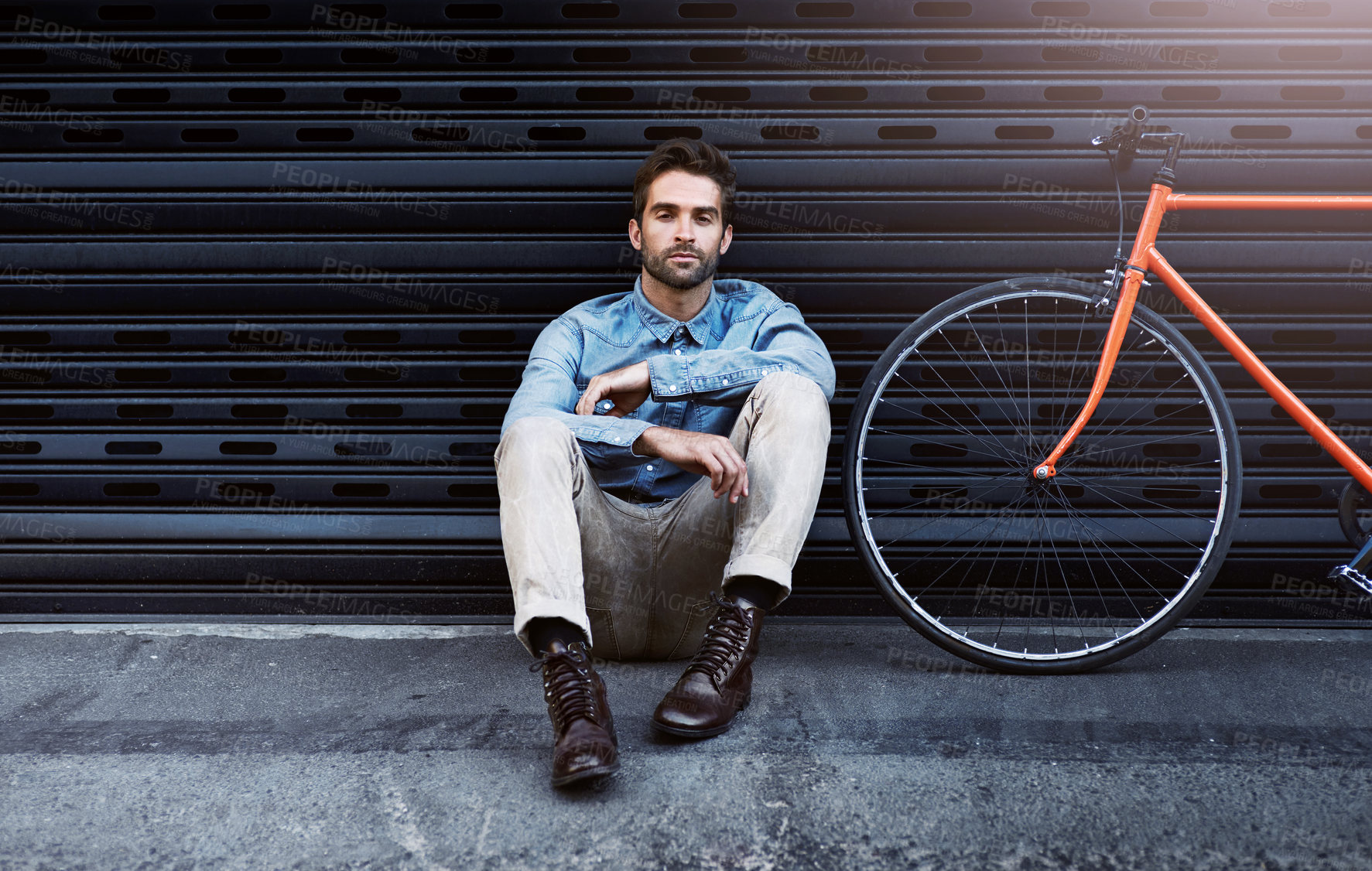 Buy stock photo Portrait, man and fashion with bicycle by wall for transport of creative business worker by lens flare. Confident, male person and beauty with elegant clothing leaning grey brick for designer career
