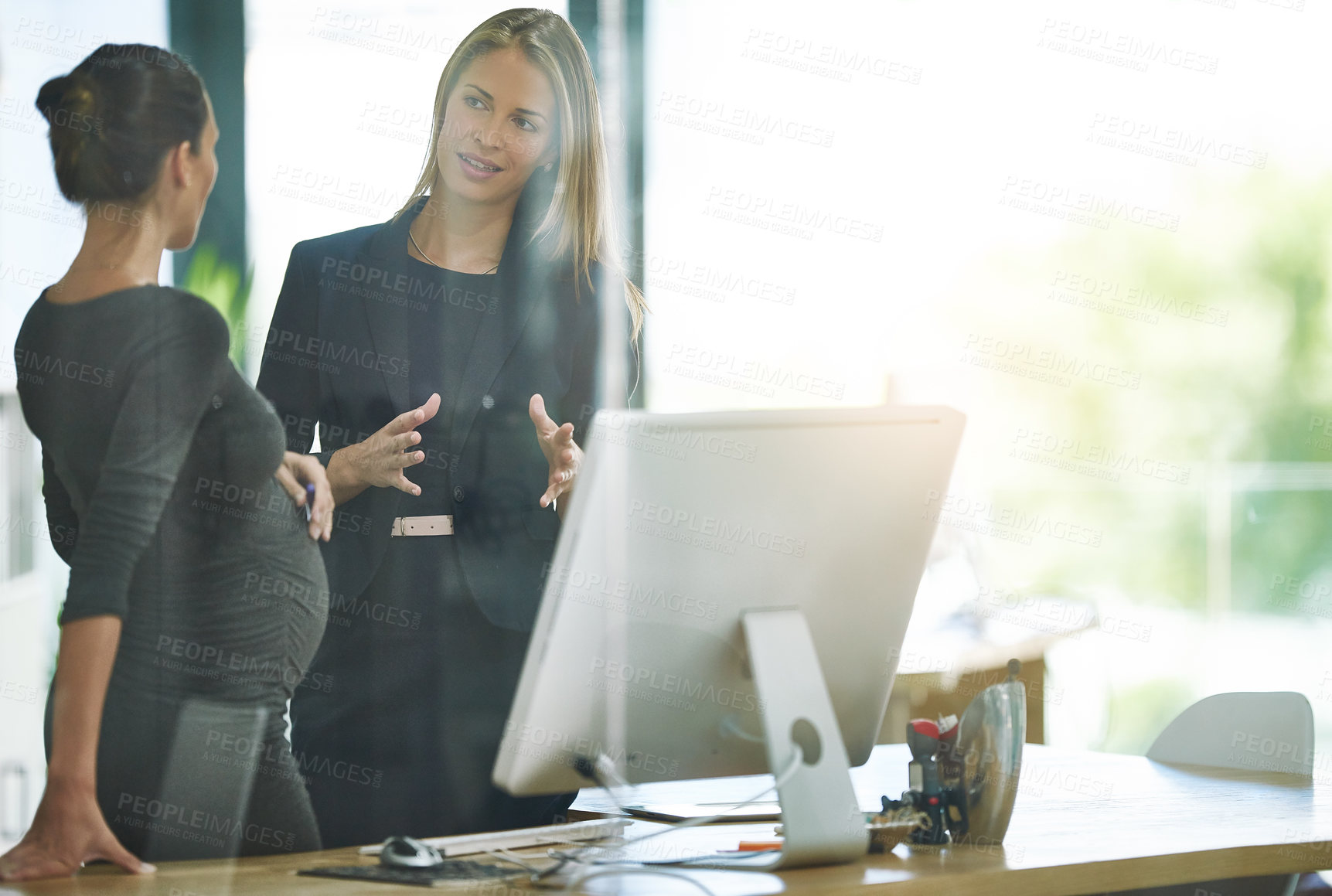 Buy stock photo Business, teamwork and pregnant woman with computer, advice and discussion at digital agency. Communication, consultant and manager planning at desk for ideas, support or collaboration in office