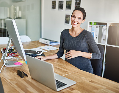 Buy stock photo Cropped portrait of a pregnant businesswoman working on her computer in the office