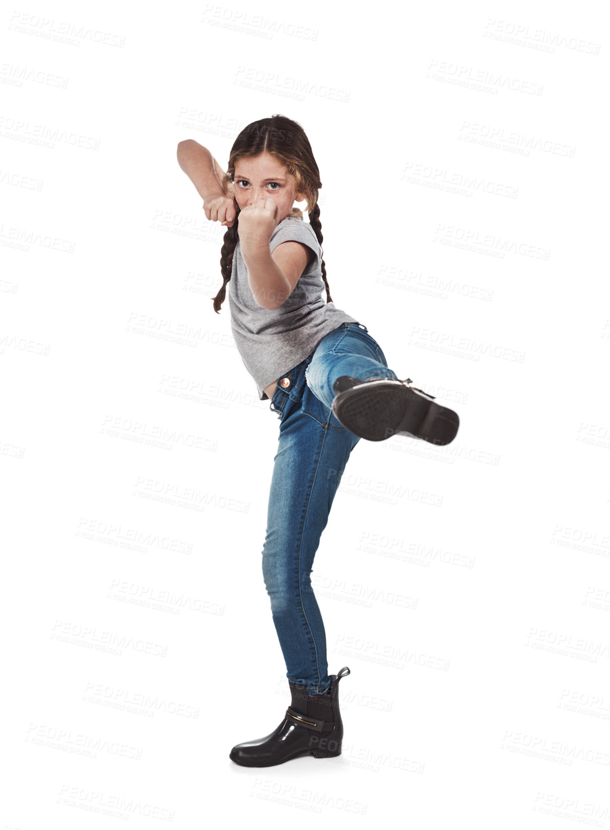 Buy stock photo Kid, girl and kick in studio on portrait for self defense and fighting lesson on white background in France. Female person, fashion and serious with boots for style, outfit and swag with fist