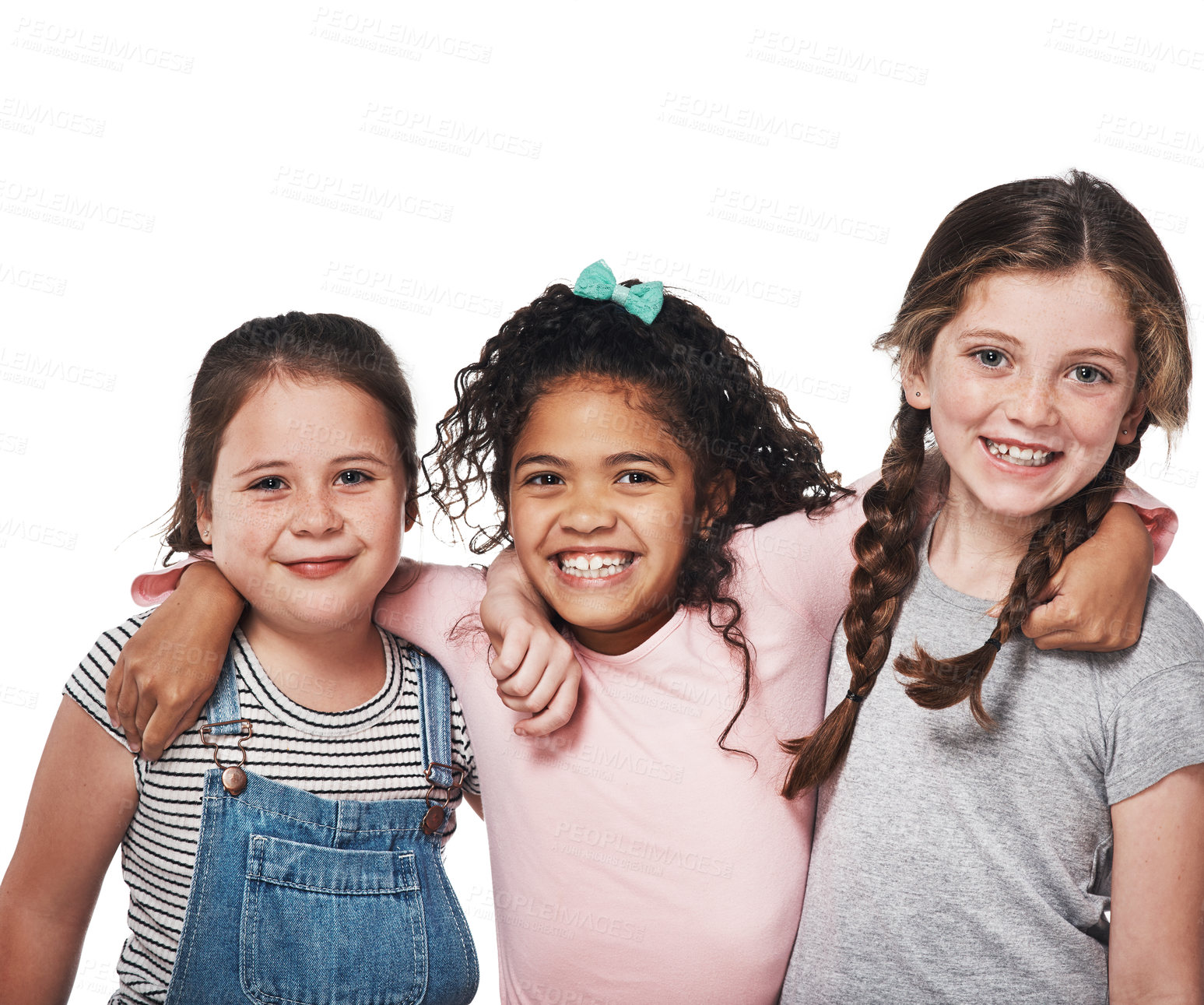 Buy stock photo Studio portrait of a group of three happy girls embracing one another against a white background