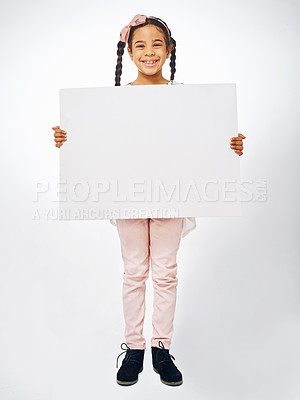 Buy stock photo Studio shot of an adorable little girl holding a blank placard