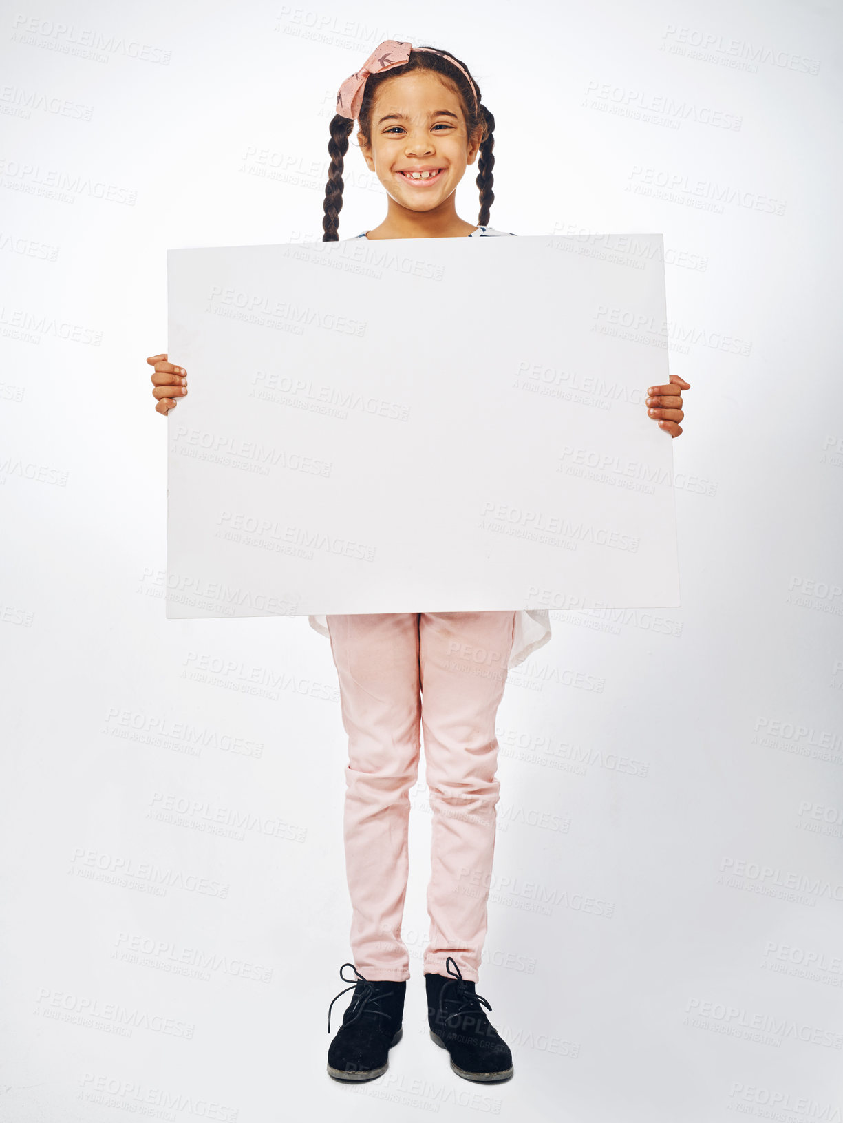 Buy stock photo Studio shot of an adorable little girl holding a blank placard