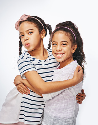 Buy stock photo Hug, portrait and smile with girl children in studio isolated on white background for bonding or love. Development, growth and support with sibling twins embracing together for family relationship