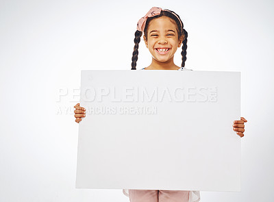 Buy stock photo Poster, happy and portrait of child on a white background for news, announcement and information. Fashion, advertising and young girl with sign, space or banner for sale, deal and bargain in studio