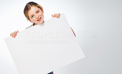 Buy stock photo Studio shot of an adorable little girl holding a blank placard